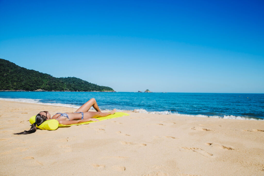 lady lies down on the beach