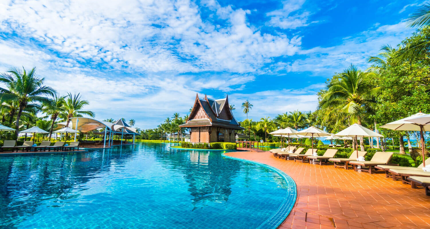 large pool with umbrellas hammocks