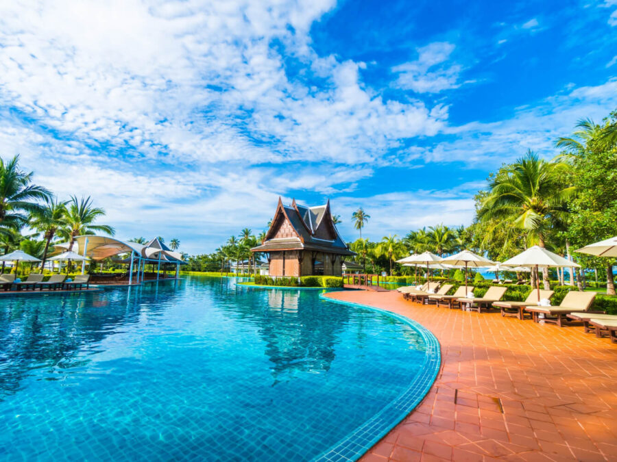 large pool with umbrellas hammocks