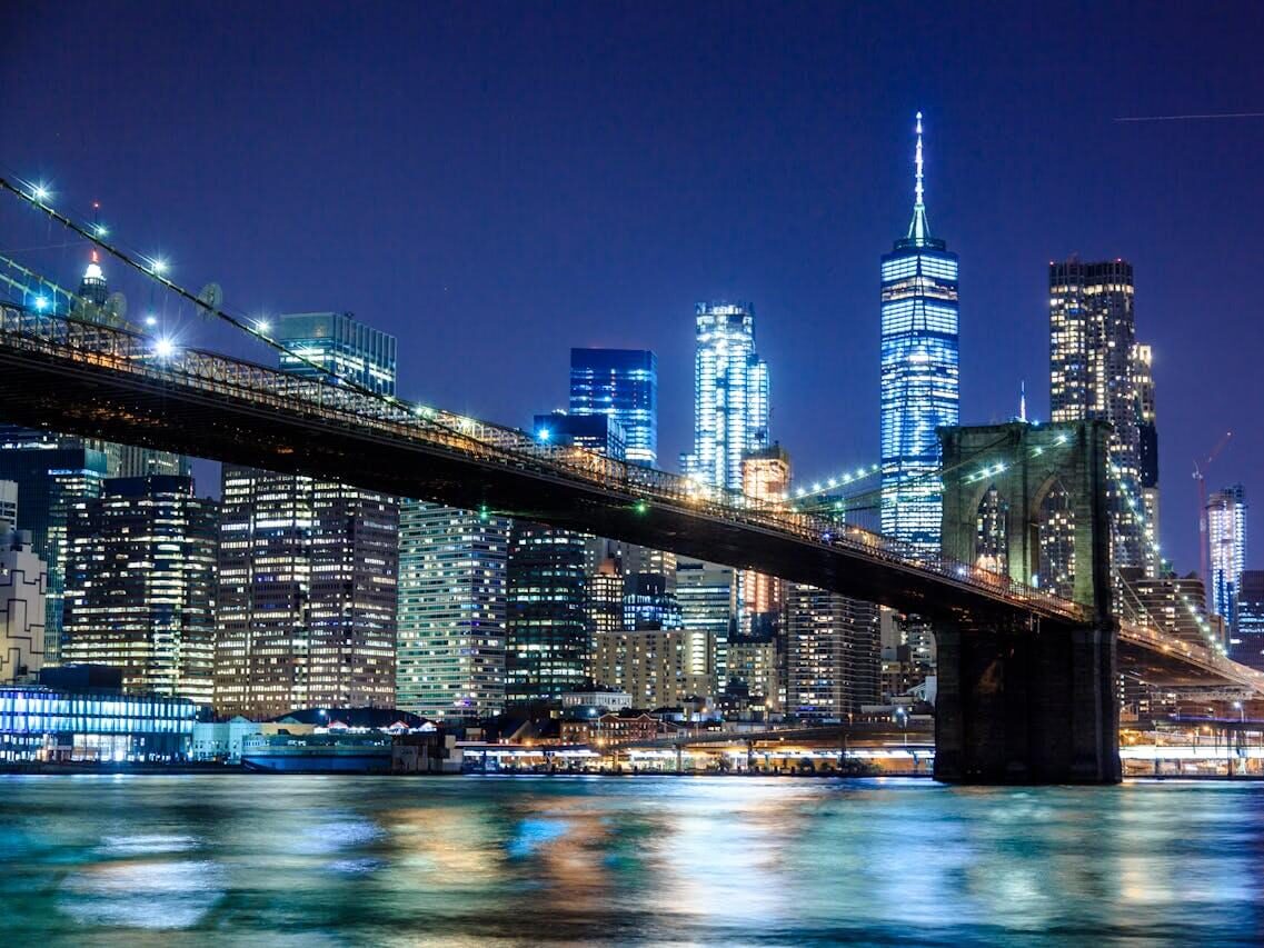 photography of bridge during night time